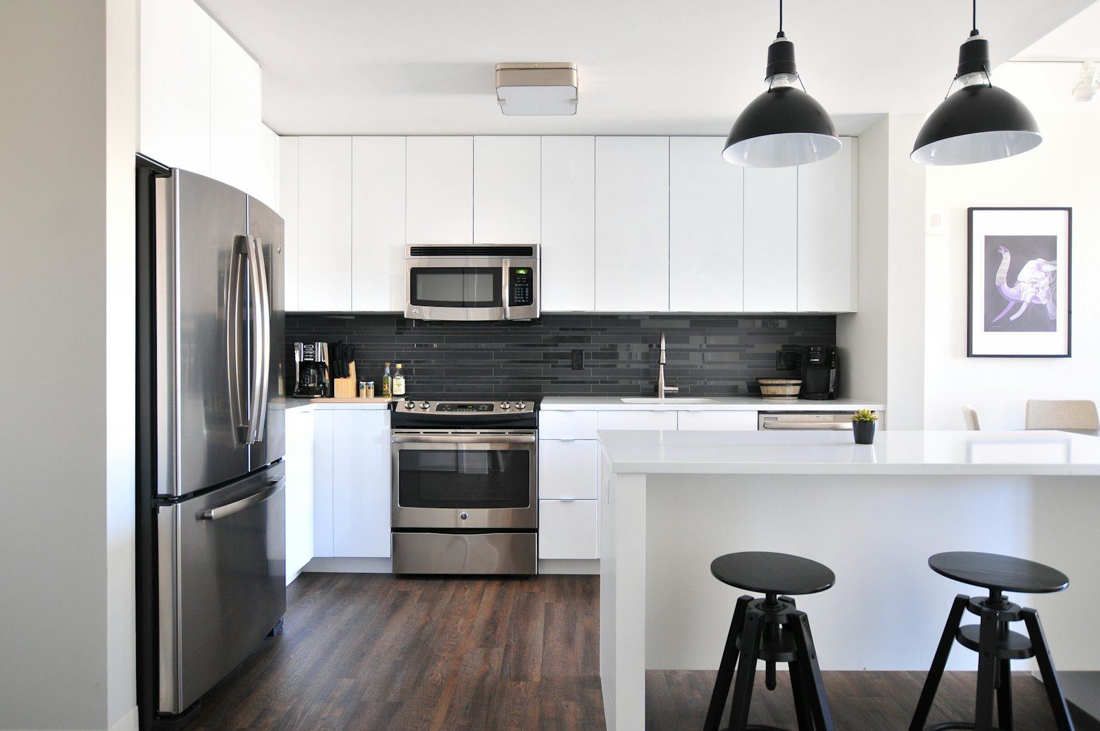 White kitchen with island and pendant lights